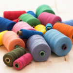 Tailoring. Many colorful threads on the table